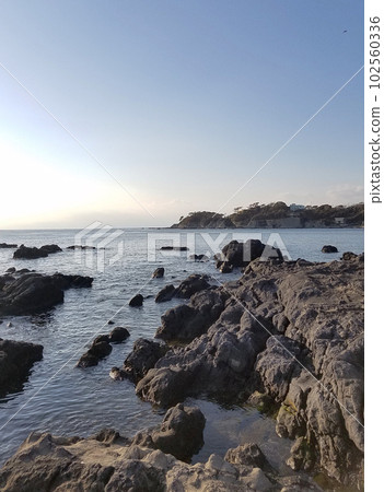 Calm sea and coast on a sunny day Calm sea and coast on a sunny day 102560336