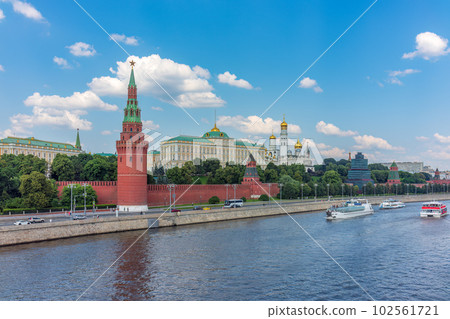 View of Kremlin with Vodovzvodnaya tower, Grand Kremlin Palace from repaired Bolshoy Kamenny Bridge in Moscow city on sunny summer day. Cruise ship sails on the Moscow river 102561721