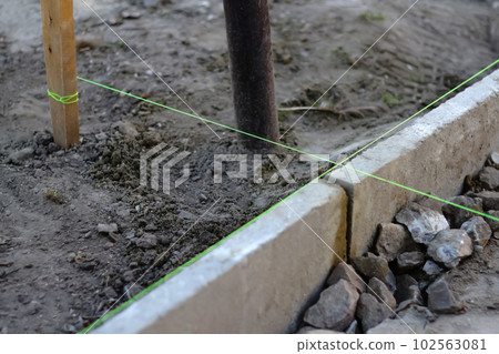 Green line. Defocus level tool. Construction industry. level tool spirit and green fishing line. Bricklayer and paving master. Pavement tools. Out of focus Green line. Defocus level tool. Construction industry. level tool spirit and green fishing line. Bricklayer and paving master. Pavement tools. Out of focus 102563081