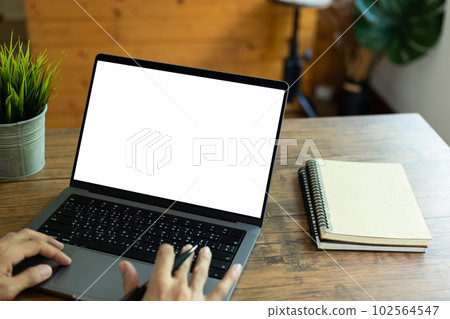 mock up empty screen notebook, businessman working on his laptop computer with blank space screen for advertising text on wood desk in Cafe mock up empty screen notebook, businessman working on his laptop computer with blank space screen for advertising text on wood desk in Cafe 102564547