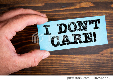 I Don't Care. A piece of paper with a text on a man's hand I Don't Care. A piece of paper with a text on a man's hand 102565539