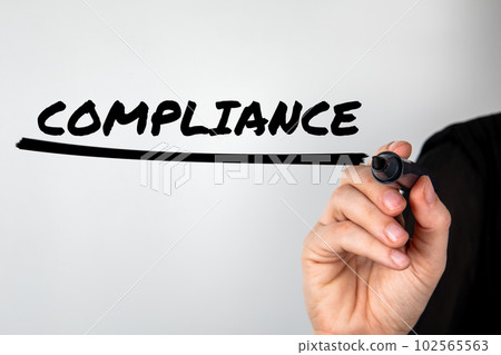 Compliance concept. Woman's hand with a black marker writes on the screen 102565563