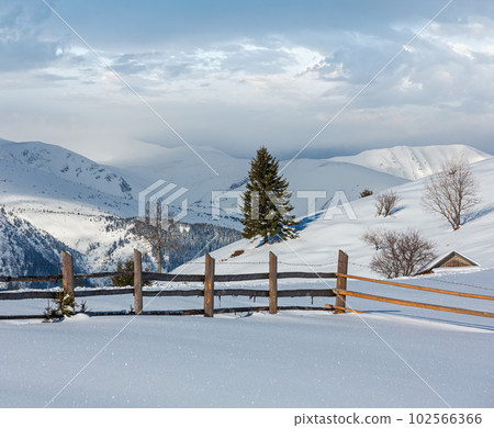 Winter mountain rural snow covered hill slope 102566366