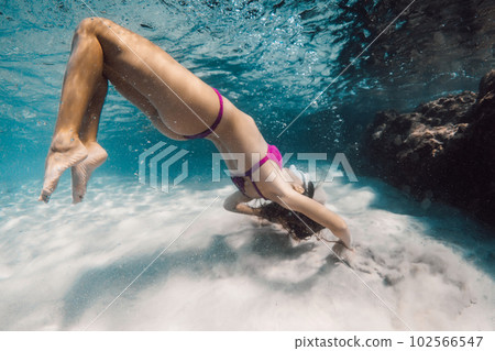 Young attractive woman with mask swim and fun underwater in transparent ocean. 102566547
