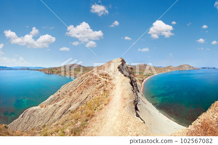 Summer rocky coastline and camping on sandy beach (Tihaja Bay (Koktebel Town in left), Crimea, Ukraine ). All peoples and cars is aunrecognizable. Summer rocky coastline and camping on sandy beach (Tihaja Bay (Koktebel Town in left), Crimea, Ukraine ). All peoples and cars is aunrecognizable. 102567082