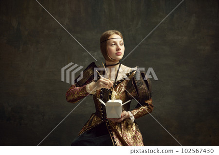 Portrait of young girl, royal person, princess in vintage dress eating noodles with chopsticks against dark green background. 102567430