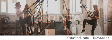 Athletic people doing crossfit training in gym Athletic people doing crossfit training in gym 102568153
