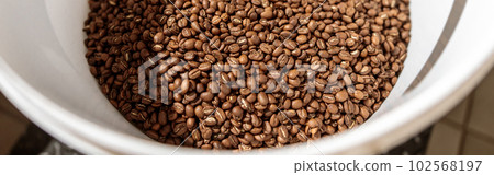 White plastic bowl with roasted coffee beans White plastic bowl with roasted coffee beans 102568197