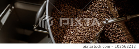 Coffee beans in cooling tray of coffee roasting machine Coffee beans in cooling tray of coffee roasting machine 102568218