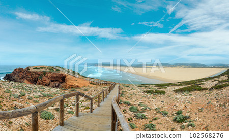 Summer Atlantic coast and lookout point at sandy beach Praia da Bordeira near river estuary. Misty view (Carrapateira, Algarve, Portugal). 102568276