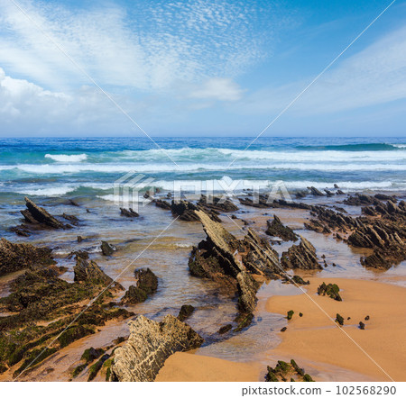 Rock formations on sandy beach (Portugal). Rock formations on sandy beach (Portugal). 102568290