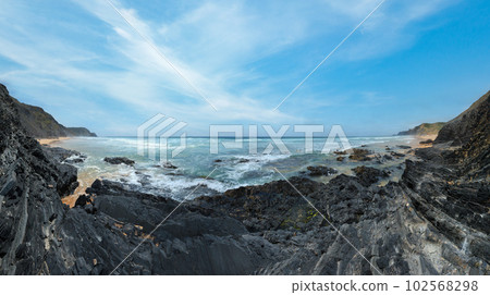 Storm on Castelejo beach with black schist stone cliffs and yelloy sand (Algarve, Portugal). Storm on Castelejo beach with black schist stone cliffs and yelloy sand (Algarve, Portugal). 102568298