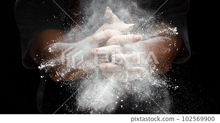 Chef prepare white flour dust for cooking bakery food. Elderly man Chef clap hand, white flour dust explode fly in air. Flour stop motion in air with freeze high speed shutter, black background Chef prepare white flour dust for cooking bakery food. Elderly man Chef clap hand, white flour dust explode fly in air. Flour stop motion in air with freeze high speed shutter, black background 102569900