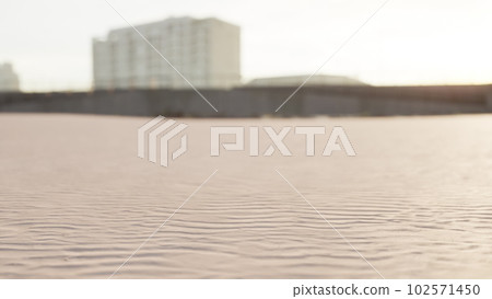 Early morning empty beach against city buildings Early morning empty beach against city buildings 102571450