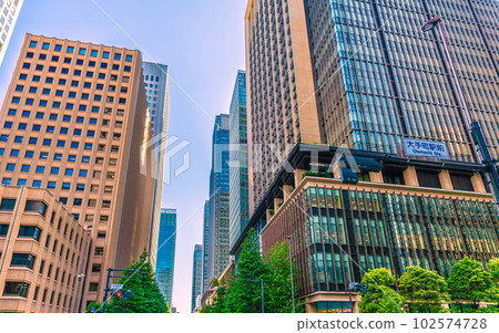 Tokyo cityscape in Japan From the intersection in front of Otemachi Station, you can see the office buildings in Marunouchi that shine in the fresh greenery and the setting sun 102574728