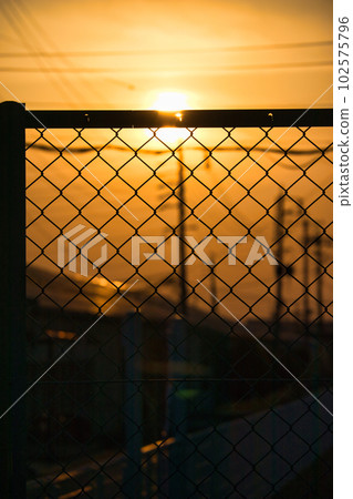 The yellow hazy sky and the silhouette of the building at sunset The yellow hazy sky and the silhouette of the building at sunset 102575796