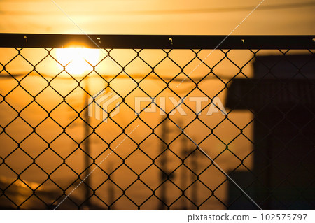 The yellow hazy sky and the silhouette of the building at sunset The yellow hazy sky and the silhouette of the building at sunset 102575797