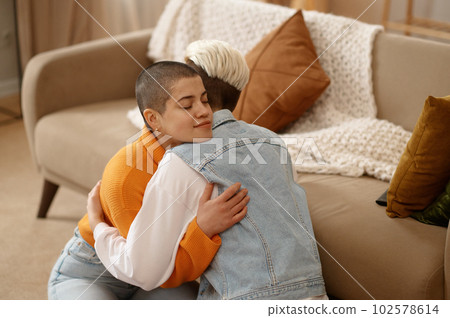 Young lesbian woman couple supporting each other, reconciling after quarrel Young lesbian woman couple supporting each other, reconciling after quarrel 102578614
