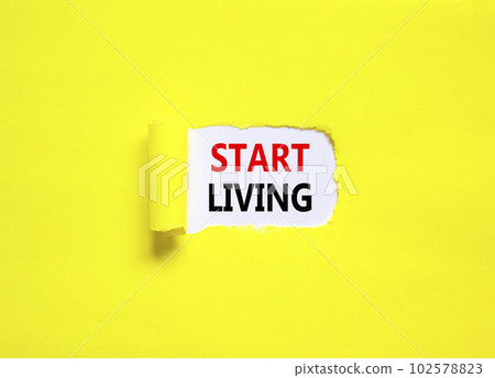 Start living symbol. Concept words Start living on beautiful white paper. Beautiful yellow table yellow background. Business and Start living concept. Copy space. 102578823