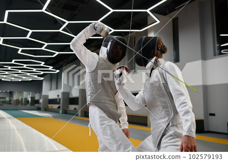 Two fencers crossed swords before fight, closeup shot of fencing dual start 102579193