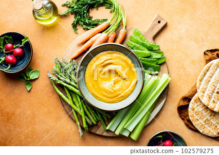Chickpea hummus served with spring vegetables Chickpea hummus served with spring vegetables 102579275