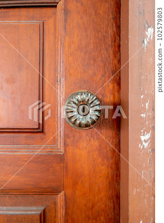 The brass door knob in the retro style. 102579803