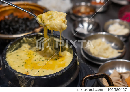 Steamed egg or Gyeran Jjim with cheese served in a bowl. Korean food Steamed egg or Gyeran Jjim with cheese served in a bowl. Korean food 102580437