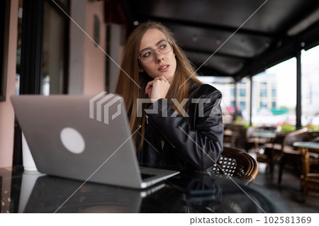 european woman model with laptop in terrace cafe european woman model with laptop in terrace cafe 102581369