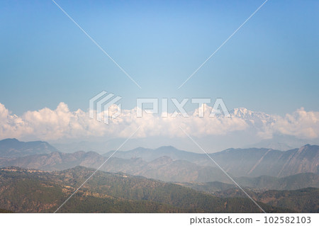 Beautiful Himalayan landscape with perspective in morning haze. Snow-capped peaks and green Himalaya mountains. Himalayas nature. India landscape. Beautiful Himalayan landscape with perspective in morning haze. Snow-capped peaks and green Himalaya mountains. Himalayas nature. India landscape. 102582103