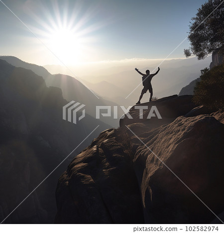 Man stands on edge of high cliff against backdrop of sunset and rejoices raising his hands up, backlighting,  102582974