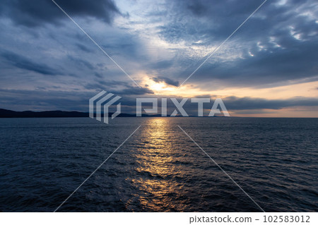 Cloudy Cloudscape during stormy everning on the West Coast of Pacific Ocean. 102583012