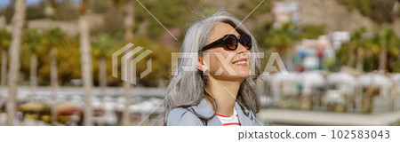Happy and healthy woman enjoying good day outdoors 102583043