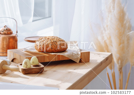 Bread on a wooden cutting board Bread on a wooden cutting board 102583177
