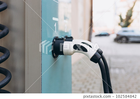 EV Car or Electric car at charging station with the power cable supply plugged. Eco-friendly alternative energy concept EV Car or Electric car at charging station with the power cable supply plugged. Eco-friendly alternative energy concept 102584842