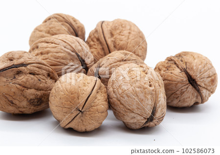Handful of walnuts on a white background Handful of walnuts on a white background 102586073