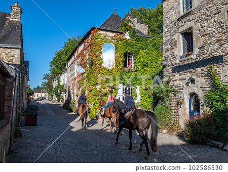 Horse Riding Through Picturesque Village Rochefort En Terre In The Department Of Morbihan In Brittany, France 102586530