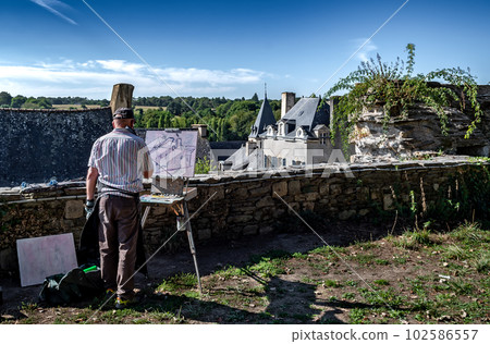 Artist Paints Picture In Scenic Village Rochefort En Terre In The Department Of Morbihan In Brittany, France 102586557
