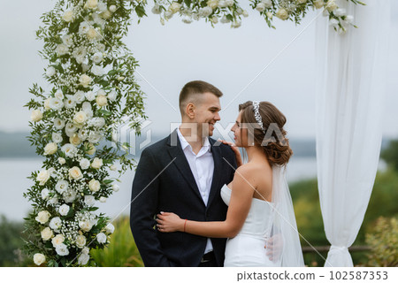 wedding ceremony of the newlyweds in a country cottage 102587353