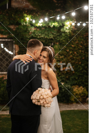 portrait of a young couple of bride and groom on their wedding day portrait of a young couple of bride and groom on their wedding day 102587381