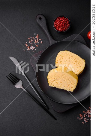 Delicious omelet with milk, spices and herbs cut into large pieces 102588518