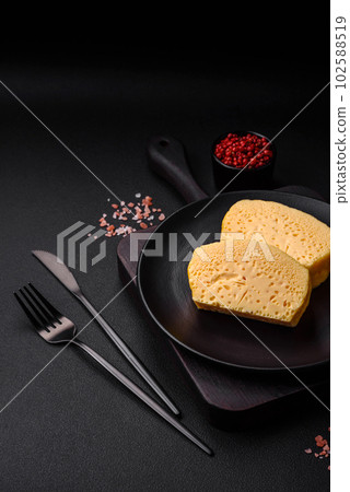 Delicious omelet with milk, spices and herbs cut into large pieces 102588519