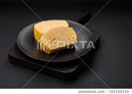 Delicious omelet with milk, spices and herbs cut into large pieces 102588520