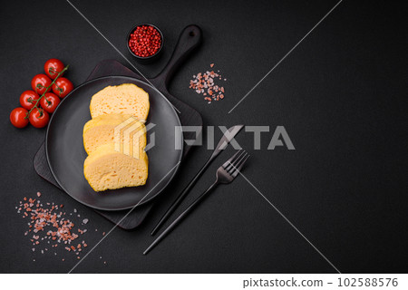 Delicious porous yellow cheese cut in large pieces on a ceramic plate Delicious porous yellow cheese cut in large pieces on a ceramic plate 102588576