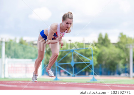 Female runner in the stadium is ready to race. Female runner in the stadium is ready to race. 102592771
