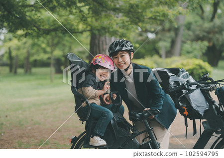 Wearing a bicycle helmet for both mother and child 102594795