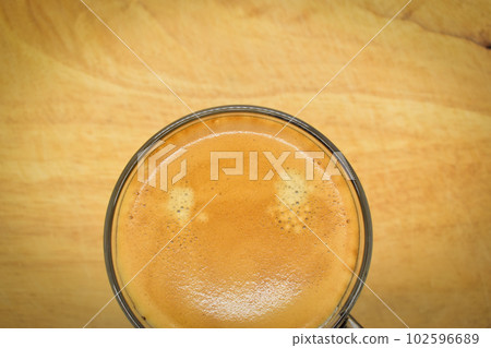 glass of hot black coffee put on wood background glass of hot black coffee put on wood background 102596689