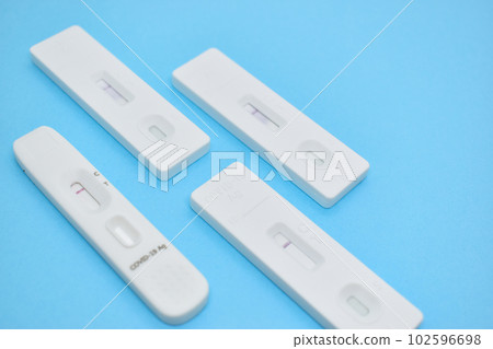 covid test kit on blue background covid test kit on blue background 102596698