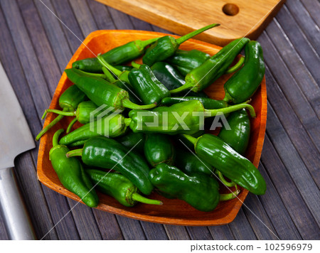 Closeup of many fresh green bell pepper on background. Healthy nutrition concept 102596979