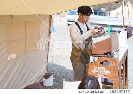 Image of a man enjoying camping 102597375