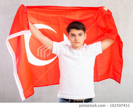 Focused young guy holding Turkey flag 102597451